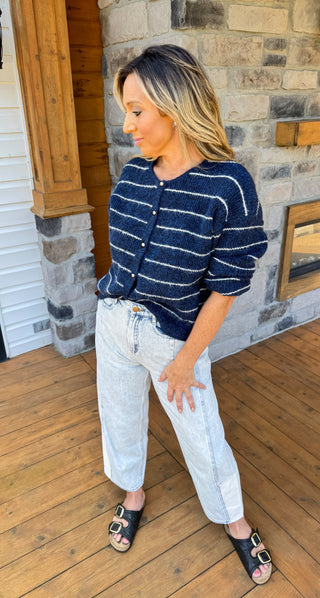 Navy blue cardigan with thin ivory stripes and gold hardware. 