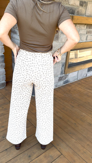 Ivory high waisted corduroy pants with light olive vintage floral pattern